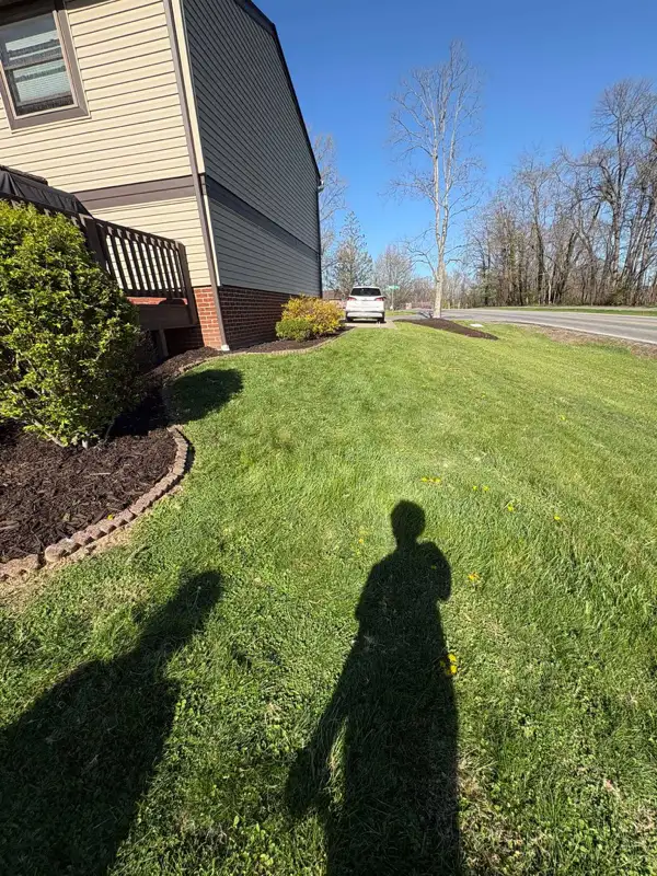 Neatly mowed side yard next to residential home — Fordeley Mowing South Fayette PA